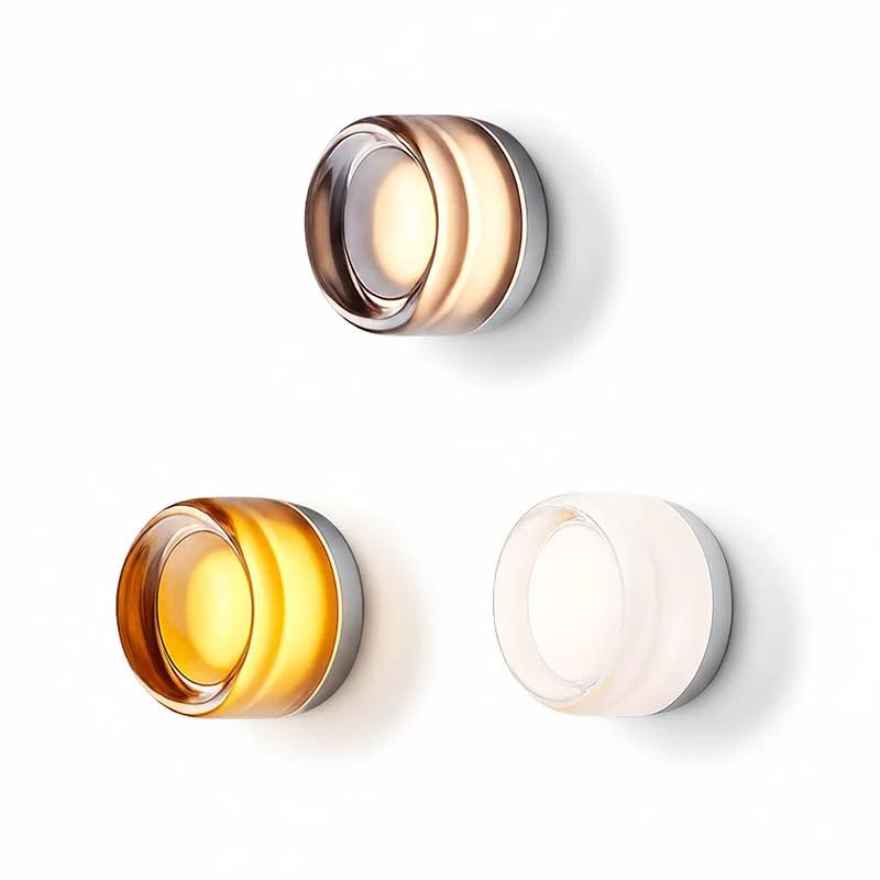 LYSEN - Nordic LED Wall Sconce - Minimalist Metal Wall Light: three circular glass wall lights in rose gold, amber and clear mounted on a white wall.