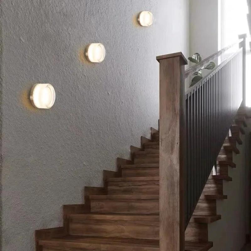 LYSEN Nordic LED Wall Sconce; four white round wall lights along stair wall, warm glow.